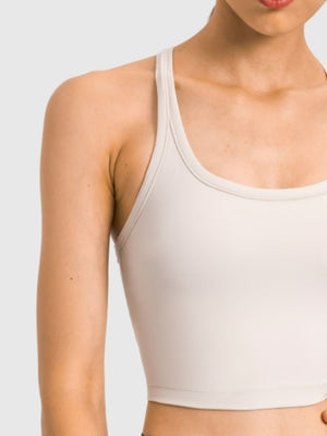 Sculpted racerback crop tank in beige with a scoop neckline.