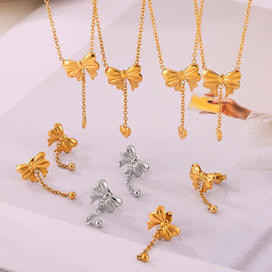 Gold and silver bow drop chain earrings with delicate chain and ball or heart charms.