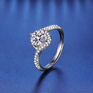 Dazzling Moissanite Halo Ring in silver with a round center stone and pave band.
