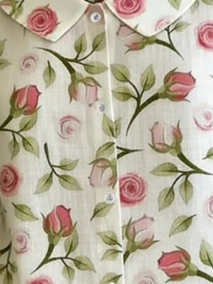 Peter Pan collar shirt in Floral print with button-down front and rose pattern.