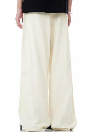 Cream relaxed fit cargo pants with multiple pockets and a wide leg.