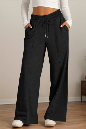 Black seamed palazzo lounge trousers with drawstring waist and pockets.