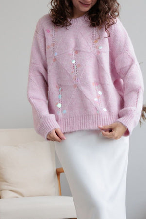 Blush pink diamond knit sweater with scattered iridescent sequins and openwork details.