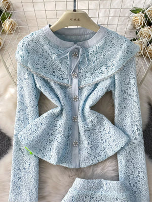Light blue lace peplum top with pearl button details and a ruffled collar.