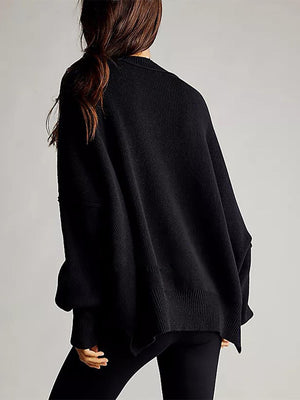 Black oversized ribbed knit sweater with drop shoulders and a relaxed fit.