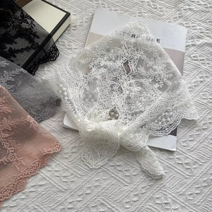 Delicate floral lace scarf in off-white with a tied knot detail.