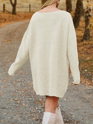 Oversized cream ribbed knit mini dress with a boat neck and long sleeves.
