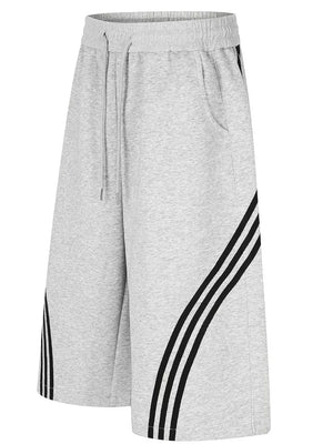 Gray wide-leg cropped sweatpants with black side stripes and drawstring waist.