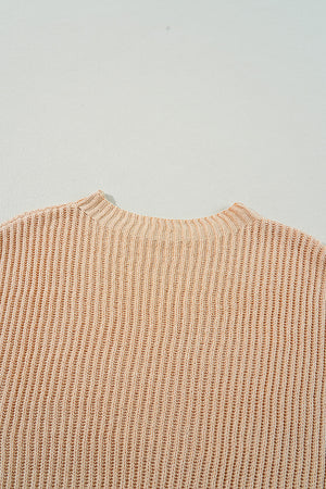 Tan ribbed knit pullover sweater with asymmetric hem detail.