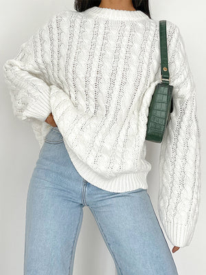White cable knit openwork sweater with crew neck and long sleeves.