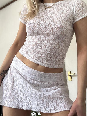 White floral lace cropped co-ord set with short sleeves and a mini skirt.