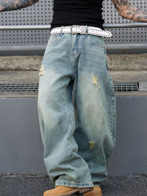 Men's light wash distressed oversized jeans with a relaxed fit and light fading.