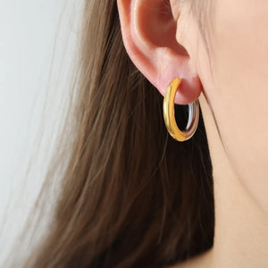 Gold segmented hoop earrings with a two-tone finish.