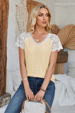 Light yellow eyelet blouse with white lace short sleeves and V-neck.