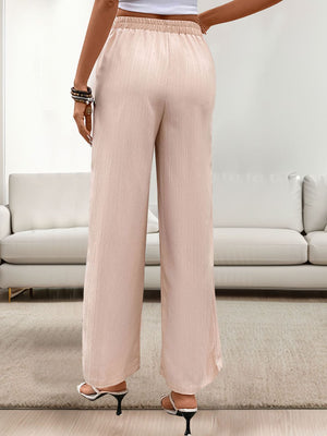 Apricot linen drawstring palazzo pants with a wide leg cut.