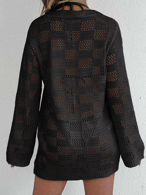 Black openwork crochet cover-up with long sleeves and a tie-front detail.