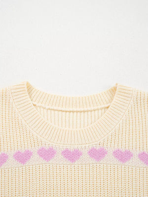 Cream knit sweater with a pink heart pattern and crew neck.