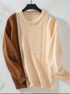 Colorblock cable knit sweater in caramel and cream with textured panels and crewneck.
