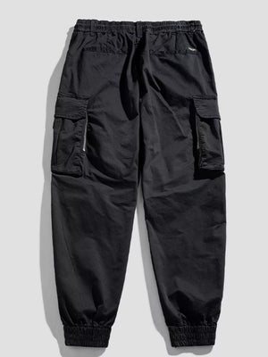 Black cargo joggers with flap pockets and zippered details.