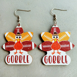 Thanksgiving turkey dangle earrings with football pattern and "Gobble" text