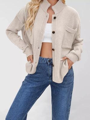Ivory knit button-down cardigan with pockets and ribbed collar and cuffs.