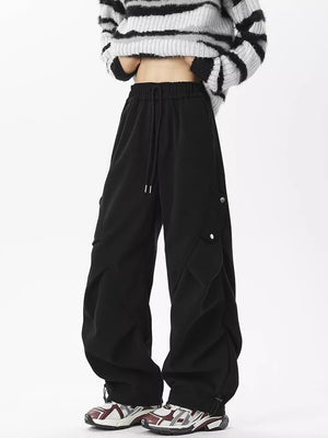 Black comfortable cargo sweatpants with drawstring waist and snap-button cargo pockets.