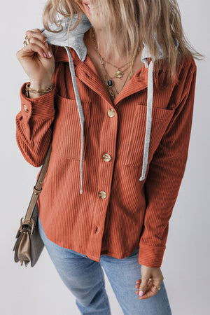 Orange-red corduroy shirt jacket with contrast gray hood and button front.