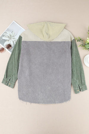 Colorblock corduroy hooded utility jacket in green, gray, and tan with frayed hem.