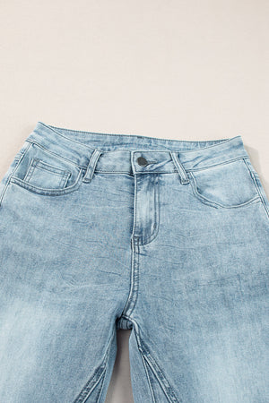 High-waisted palazzo flare denim jeans in medium wash with a button fly and five-pocket styling.