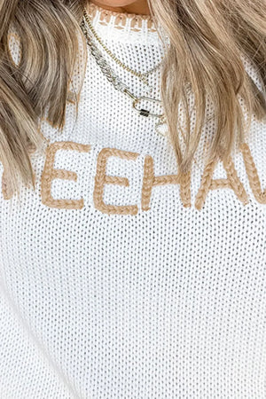 White knit sweater with "Yeehaw" embroidery and stitch trim detail.
