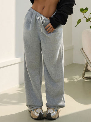 Light Gray relaxed sweatpants with drawstring waist and pleat details.