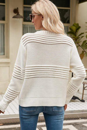 Cream open-knit mock neck sweater with horizontal openwork details and ribbed cuffs.