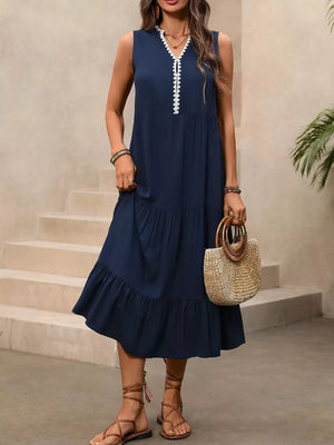 Navy midi dress with ruffled hem and white trim detail, sleeveless V-neck.