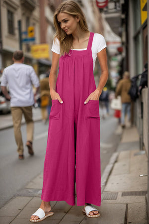 Hot Pink gathered bib wide-leg jumpsuit with square neckline, square pockets, and tie back detail.