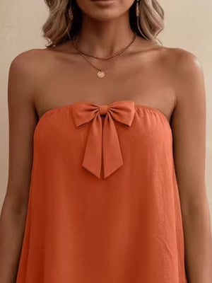 Orange strapless tube top with a large bow detail.
