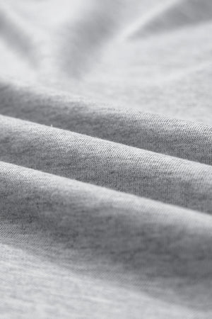 Gray sweatshirt fabric detail showing soft texture and folds.