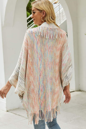 Textured stripe fringe cape with pastel multicolor yarn and fringe detail.