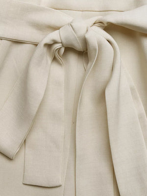 Cream belted maternity romper with a tie waist detail