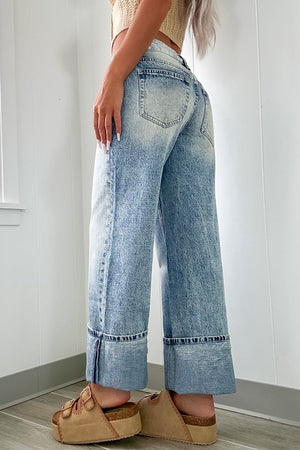 Cuffed hem washed denim trousers in medium acid wash with a wide leg