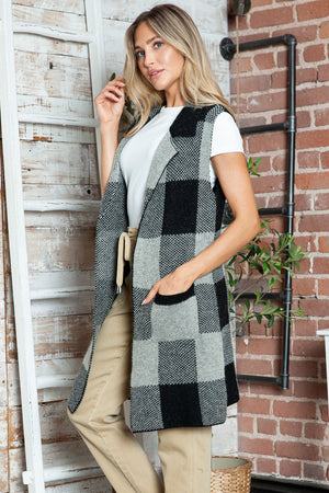 Geometric knit duster vest in black and tan checkered pattern with pockets.