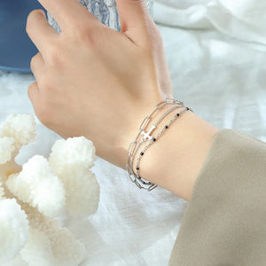 Silver layered chain and bead bracelet trio with cross charm
