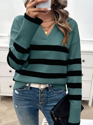 Turquoise and black striped knit polo sweater with a V-neck and collared neckline.