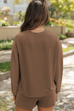 Brown ribbed knit matching set with long sleeves and shorts.