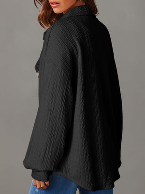 Black textured oversized button-down shacket with a collared neckline and long sleeves.