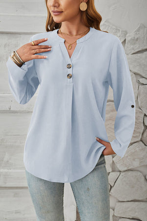 Light blue V-neck button-down blouse with cuffed sleeves and a relaxed fit.