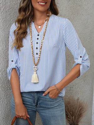 Light blue stripe v-neck blouse with roll-up sleeves and button detail.