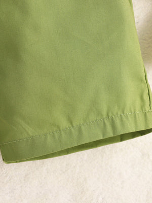 Green cotton baby shorts with stitched hem detail