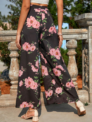 Black palazzo trousers with a pink floral print and wide leg.