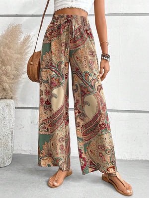 Paisley palazzo trousers with drawstring waist in Multicolor, featuring a boho print and wide leg cut.