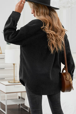 Fleece shirt jacket in black with patch pockets and a relaxed fit.
